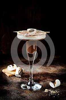 Toasted smores martini with chocolate liquor, cream, marshmallow and graham cracker rim.