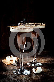 Toasted smores martini with chocolate liquor, cream, marshmallow and graham cracker rim.