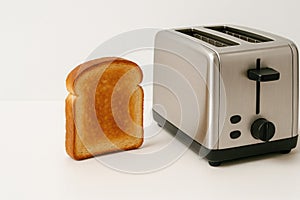 Toasted toast sits next to the toaster. Space for text.
