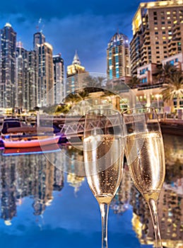 Toasting with champagne against Dubai marina in United Arab Emirates
