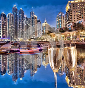 Toasting with champagne against Dubai marina in United Arab Emirates