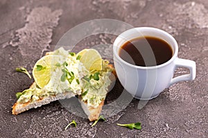 Toasts with avocado pate, fresh microgreen and cup of coffee