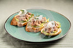 Toasts with canned tuna and avocado. Healthy food and diet breakfast