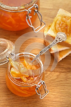 Toasts and orange jam in a glass jar