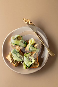 Toasts with pate on a beige background