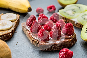 Toasts with raspberries, bananas and kiwi. Healthy lifestyle and vegan concept