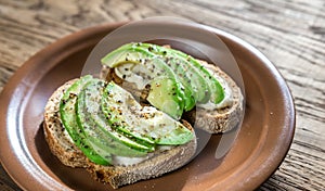 Toasts with tahini sauce and sliced avocado