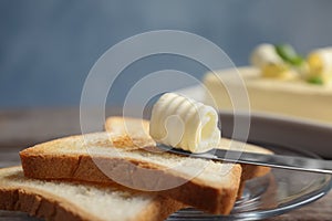 Toasts with tasty butter curl on plate