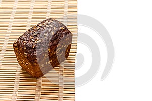 Toasty Organic Loaf of rye Bread on wooden plank isolated on white