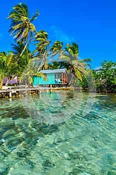 Tobacco Caye - Relaxing at Cabin or bungalow on small tropical island at Barrier Reef with paradise beach, Caribbean Sea, Belize,
