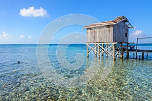 Tobacco Caye - Relaxing at Cabin or bungalow on small tropical island at Barrier Reef with paradise beach, Caribbean Sea, Belize,