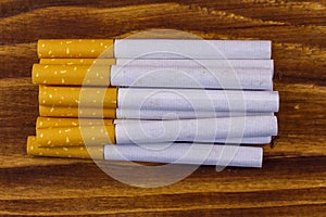 Tobacco cigarettes on wooden table