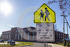 Tobacco Free Zone sign with student crossing sign in front of a public high school in Maryland.