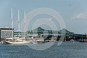 Tobin bridge in Boston MA, USA and the Athena 295 foot yacht docked at the Boston harbor