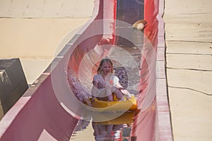 On toboggan down a steep water slide