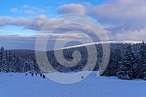 Toboggan piste in winter against cloudy sky