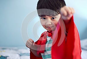 Today, I will be my own superhero. Portrait of an adorable little boy pretending to be a superhero while playing at home