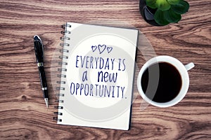 Today Inspirational quote- Everyday is a new opportunity. With positive motivational text on a notebook, a cup of morning black