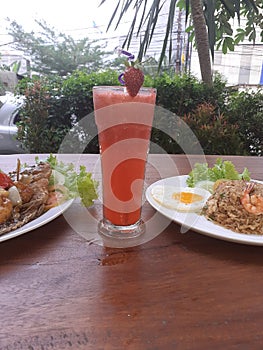 Today`s menu is fried rice, beef eye eggs, sweet and sour carp, and a glass of strawberry juice