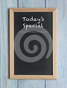 Today`s Specials - words in white chalk on a blackboard isolated on blue wood