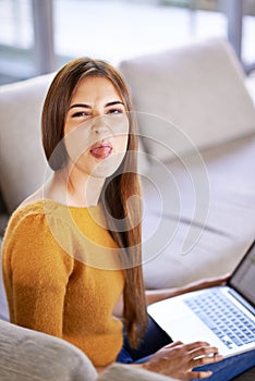 Todays all about wireless fun. an attractive young woman relaxing on the sofa with her laptop.