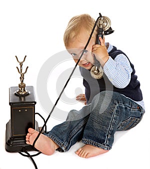 Toddler with antique telephone
