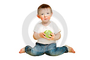 Toddler baby eats a sour apple on a studio isolated on a white backgro