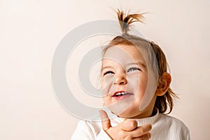 Toddler baby girl with fountain hairstyle and smiling with her teeth