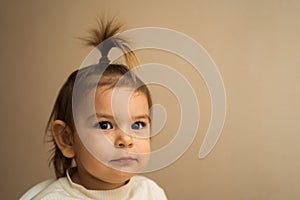 Toddler baby girl with fountain hairstyle and smiling with her teeth