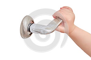 Toddler baby opens the door holding the door handle, child hand close-