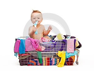 Toddler in basket with clothes