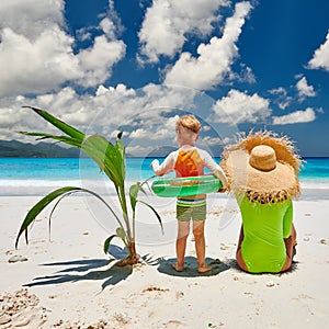 Toddler boy on beach with mother