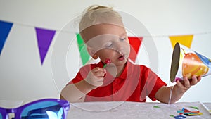 Toddler boy with candy on stick. Birthday party afterparty. Gimbal motion