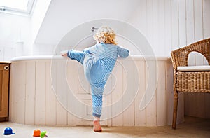 Toddler boy in a dangerous situation in the bathroom.