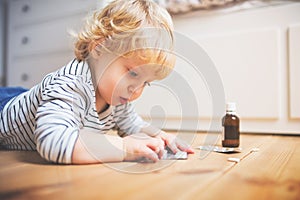 Toddler boy in a dangerous situation at home.