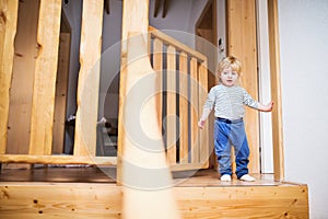 Toddler boy in dangerous situation at home. Child safety concept.