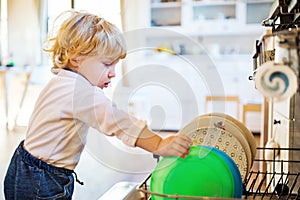 Toddler boy in dangerous situation at home. Child safety concept.