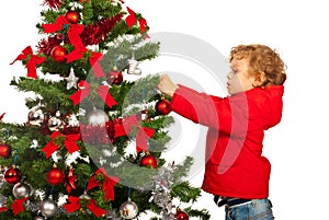 Toddler boy decorate Christmas tree