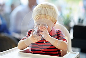 Toddler boy drinking water