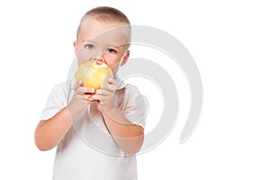 Toddler boy eating an apple isolated over white
