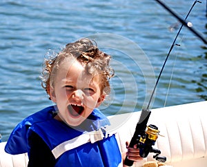 Toddler Boy fishing on a boat