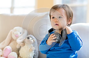 Toddler boy listening to music with headphones