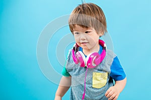 Toddler boy listening to music with headphones