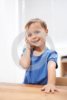 Toddler, boy and phonecall at home, playing and communication with technology. Happiness, calling and conversation for