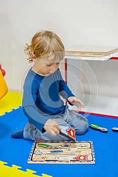 Toddler boy playing in developing the game