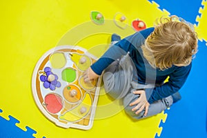 Toddler boy playing in developing the game