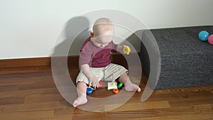 Toddler boy playing educational game with colorful wooden figures