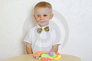 A toddler boy playing with kinetic pasticine, a great activity to develop fine motor skills