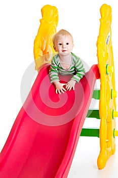 Toddler boy playing on the slide