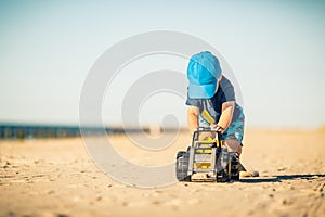 Toddler boy playing on a sunny beach